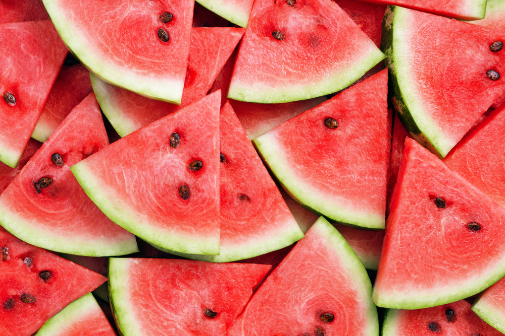 Close-up of pink watermelon slices piled on top of one another.