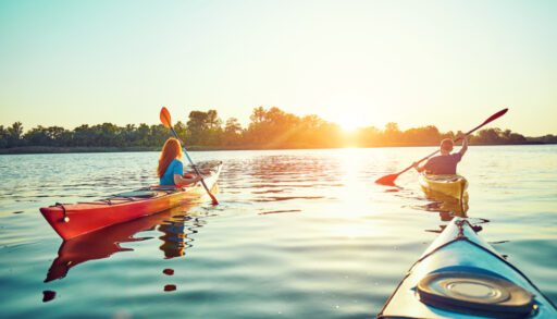 Group of people kayaking on a lake.