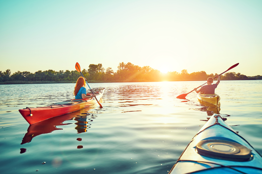 Group of people kayaking on a lake.