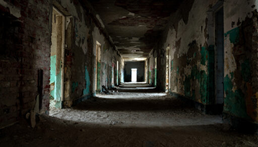 Hallway of an abandoned, decaying building.