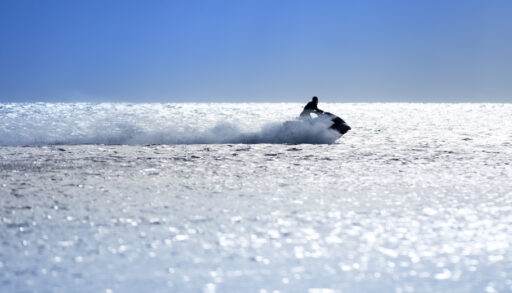 Person riding a jet ski on open water.