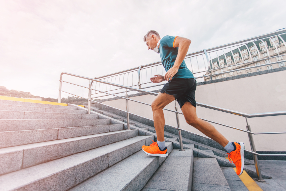 Man exercising by running up concrete stairs.