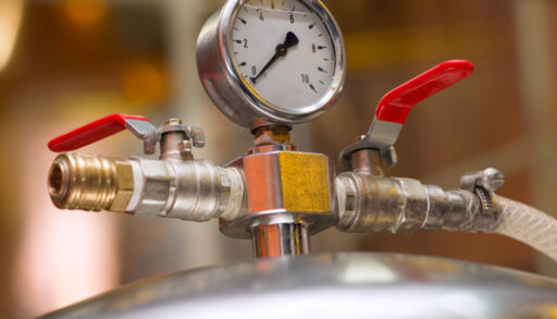 Close-up of a gauge on brewery equipment.