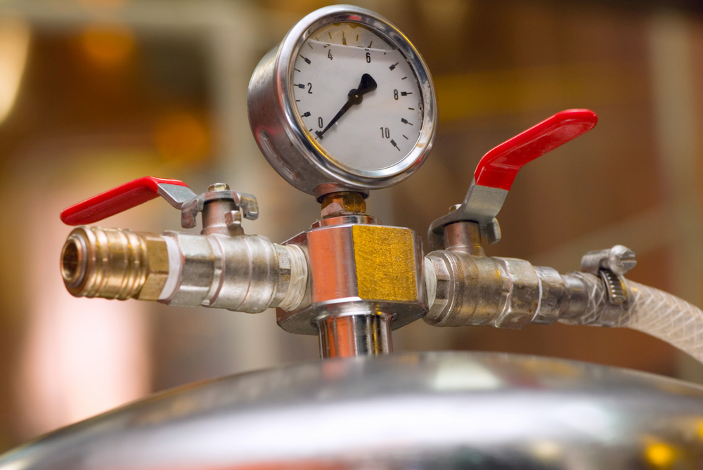 Close-up of a gauge on brewery equipment.