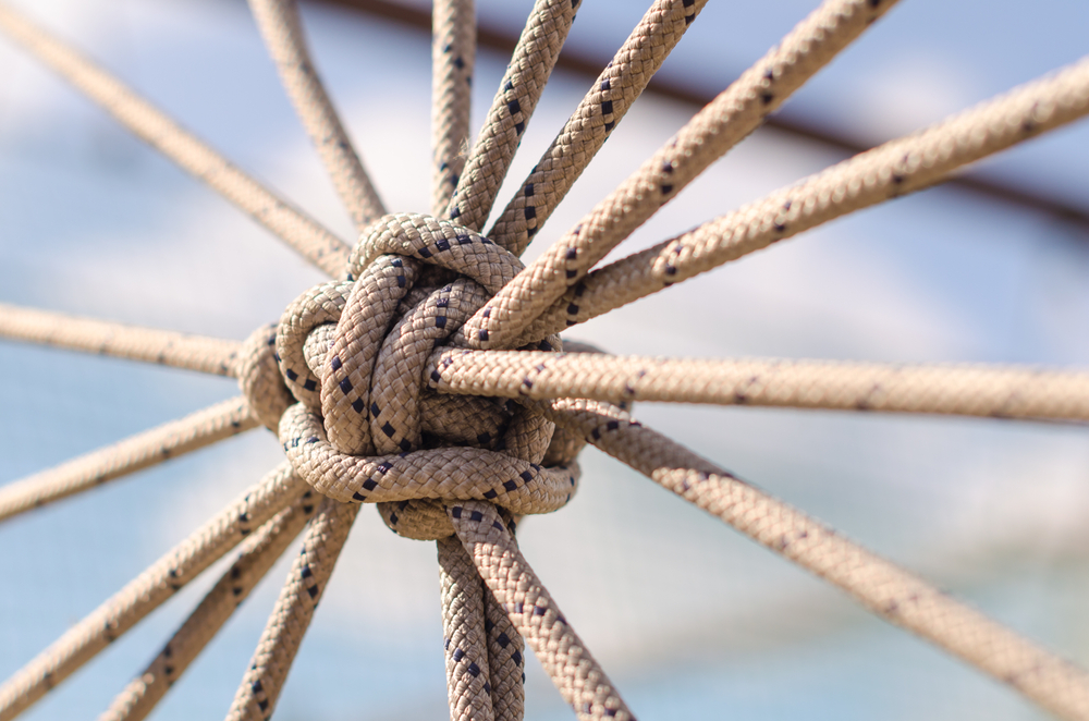 Close-up of a knot created by a web of ropes.