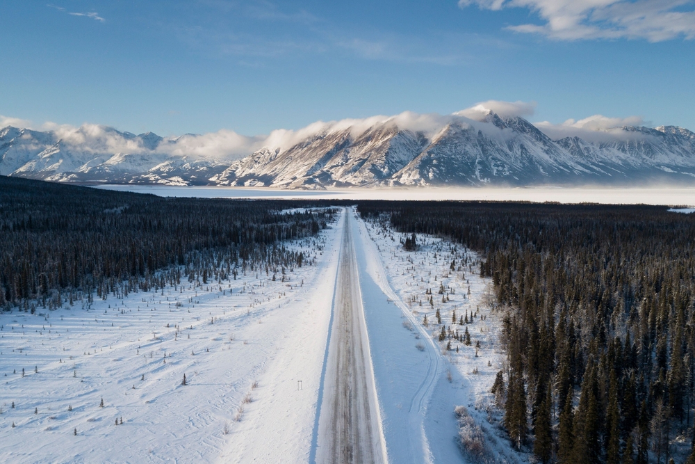 Road running towards the mountains in Whitehorse, Yukon.
