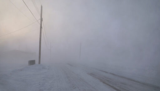 Road disappearing in a snow storm in Arviat, Nunavut.