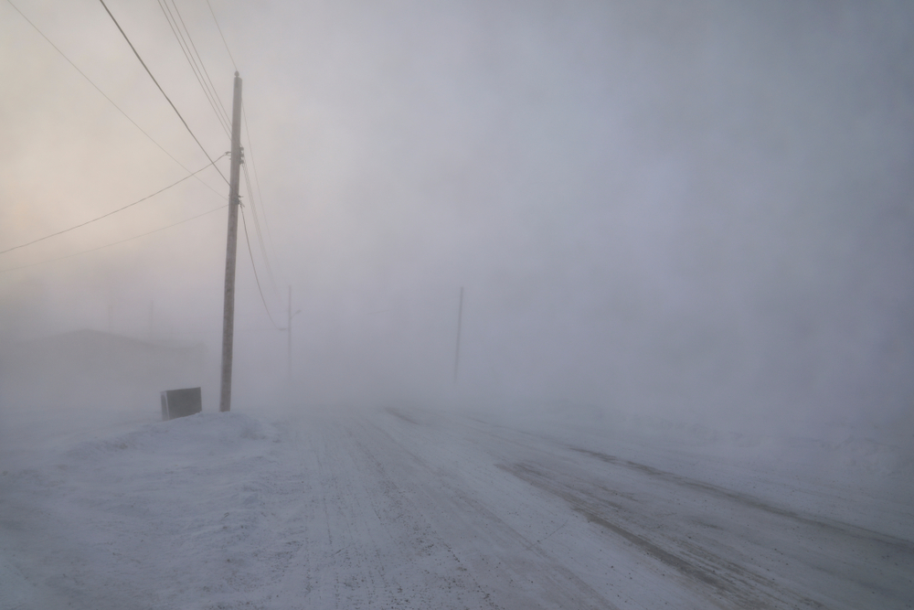 Road disappearing in a snow storm in Arviat, Nunavut.