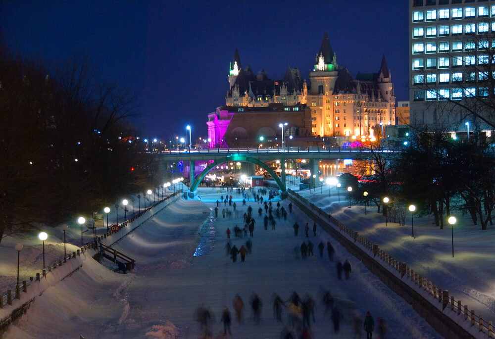 Skaters on the Rideau Canal at night in Ottawa, during Winterlude.