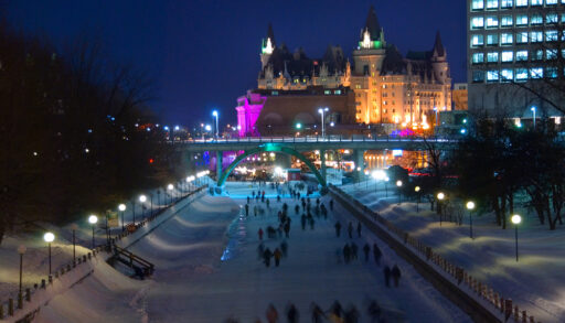 Skaters on the Rideau Canal at night in Ottawa, during Winterlude.