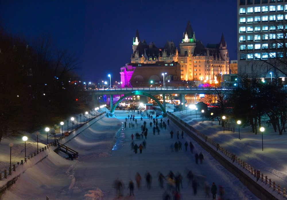 Skaters on the Rideau Canal at night in Ottawa, during Winterlude.