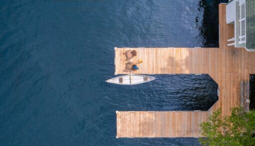 Aerial view of a cottage dock with a canoe.