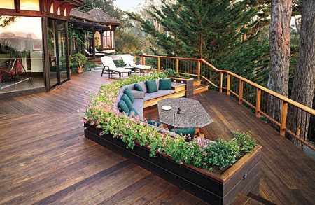 large deck with built-in seating and flower bed