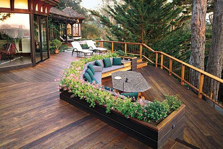 large deck with built-in seating and flower bed