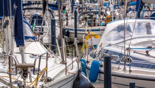 Close-up of two boats docked in a marina.