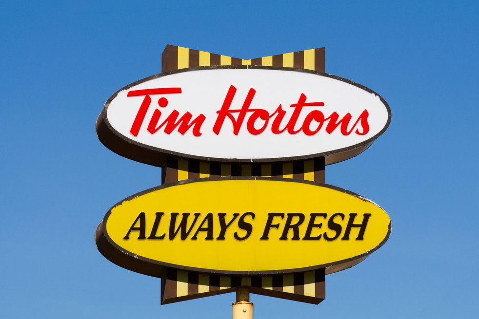 Close-up of a white and yellow Tim Hortons sign.