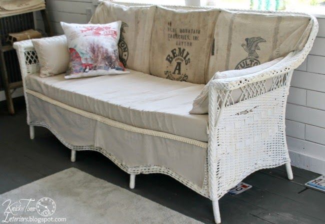 A wicker couch covered with grain sacks