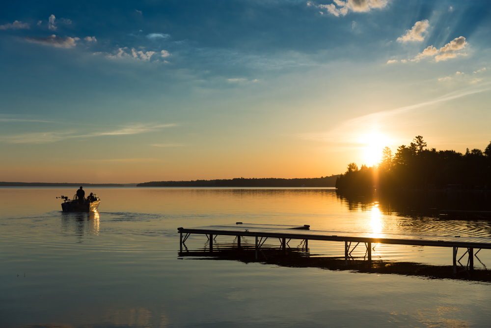 A fishing boat on Balsam Lake at sunset, Kawartha, Ontario.