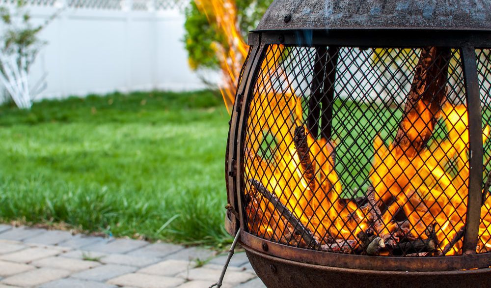 Close-up of a fire pit in a backyard.