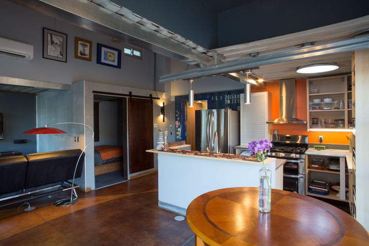 Detailed view of living room, kitchen and bedroom in cabin.