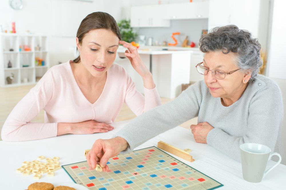 A young and an older women playing Scrabble.
