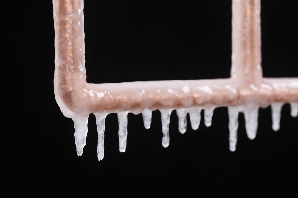 Close-up of a frozen copper pipe.
