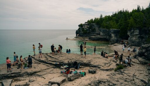 People gathered on a beach in Bruce Peninsula National Park, Ontario.