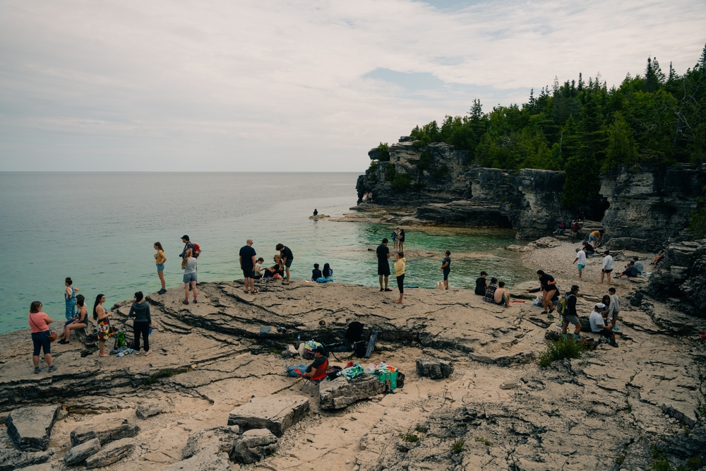 People gathered on a beach in Bruce Peninsula National Park, Ontario.