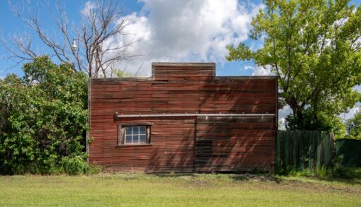 Old, abandoned red building in the ghost town of Fleet, Alberta.