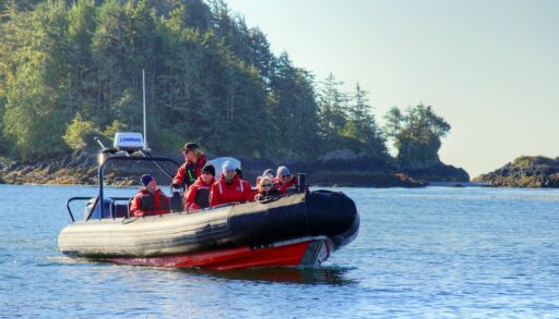 A group of whale watchers in a red boat in Tofino, British Columbia.