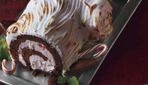 A cake in the shape of a log with white icing