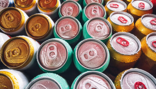 The tops of colourful beer cans lined up in rows.