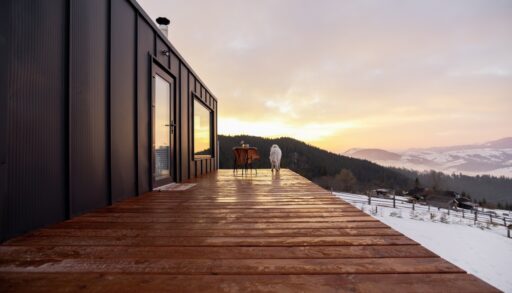 View of a tiny home terrace overlooking a snow-covered landscape.