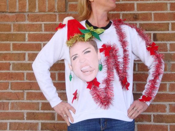 A sweater with Miley Cyrus wearing a Santa hat
