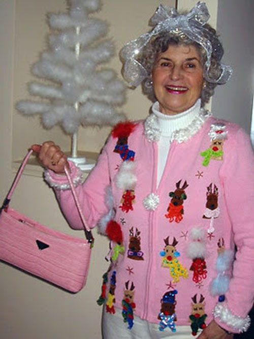 Older woman wearing light pink reindeer sweater