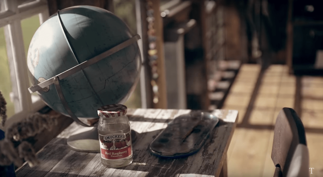 A globe and a jar on a wooden desk