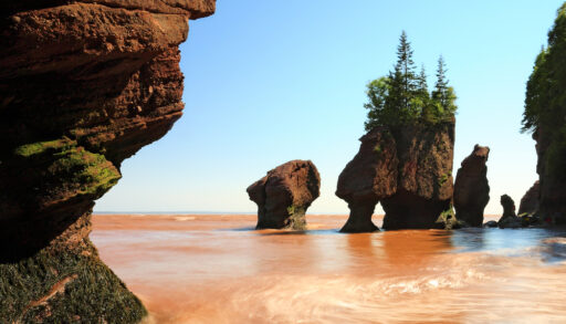 Unique rock formations along the shore of a water body.