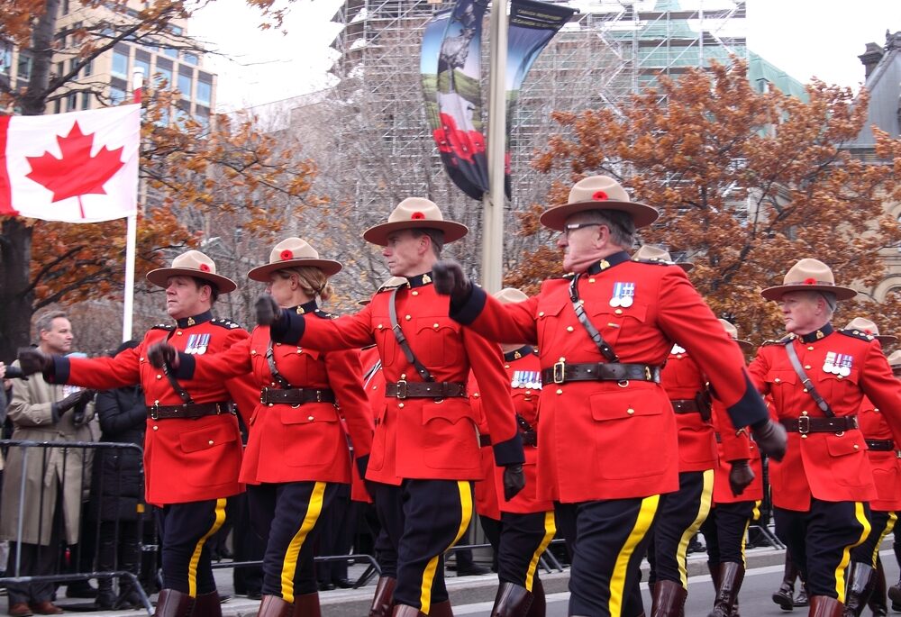 Canadian mounties in signature red uniform marching down a street in Ottawa.