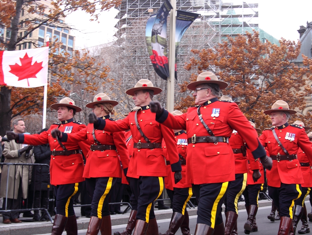 Canadian mounties in signature red uniform marching down a street in Ottawa.