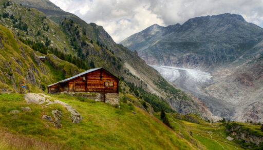 Wooden cabin nestled in a mountain in the fall season.