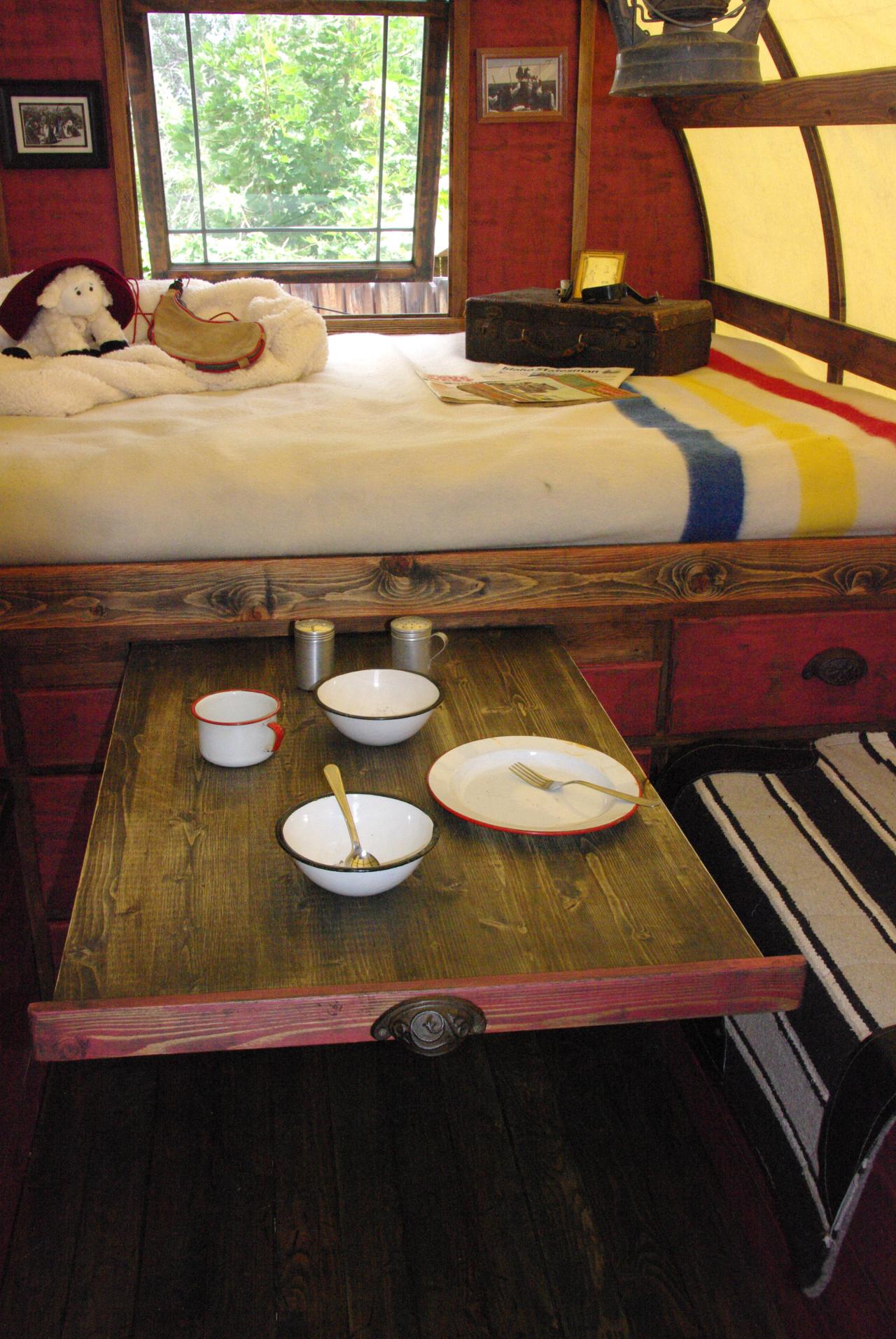 Bed with pull-out tray