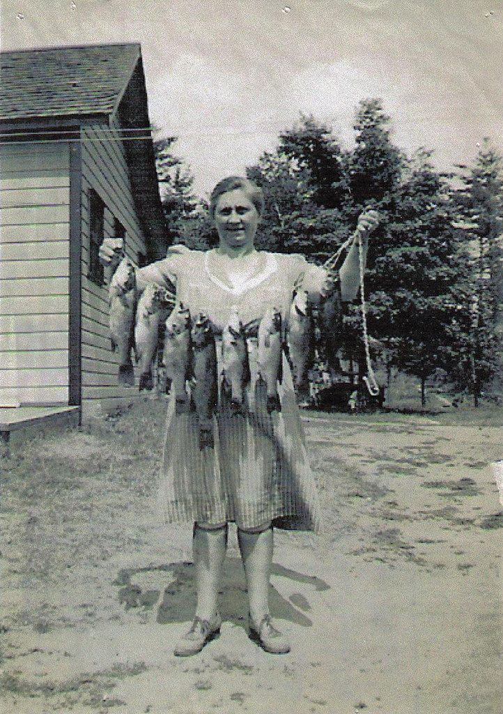 Woman with a string of fish, black and white