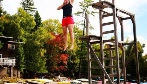 Woman jumping off diving platform