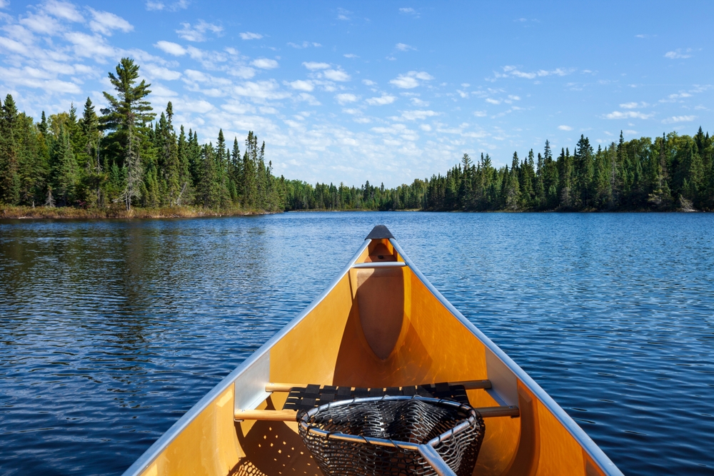 Point of view from inside a yellow canoe on the water.