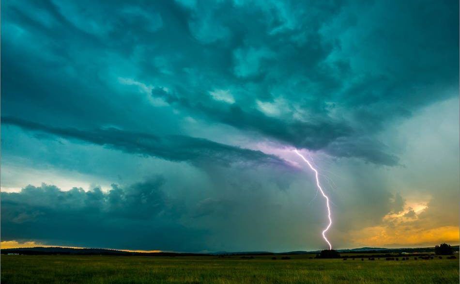 Lightning over a green field