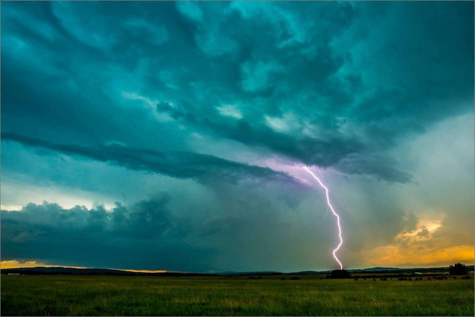 Lightning over a green field