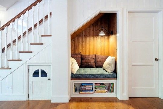 A reading nook with a tiny door next to it