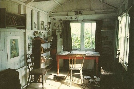A room with a desk and lots of knickknacks