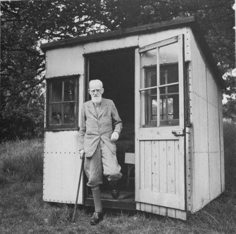 George Bernard Shaw outside a hut