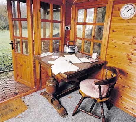 Desk inside shack with wood walls